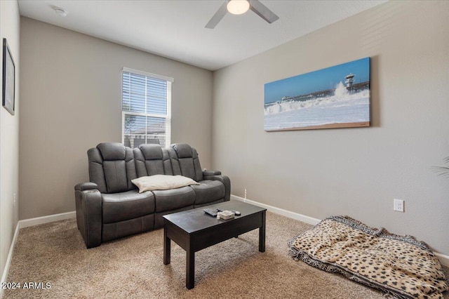 living room with light carpet, ceiling fan, and baseboards
