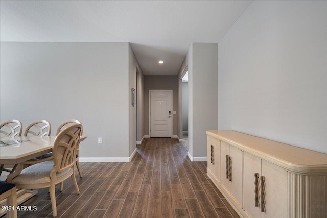 hall featuring recessed lighting, dark wood-type flooring, and baseboards