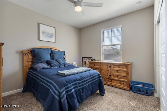 bedroom with ceiling fan, carpet flooring, and baseboards