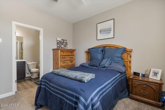 carpeted bedroom featuring connected bathroom