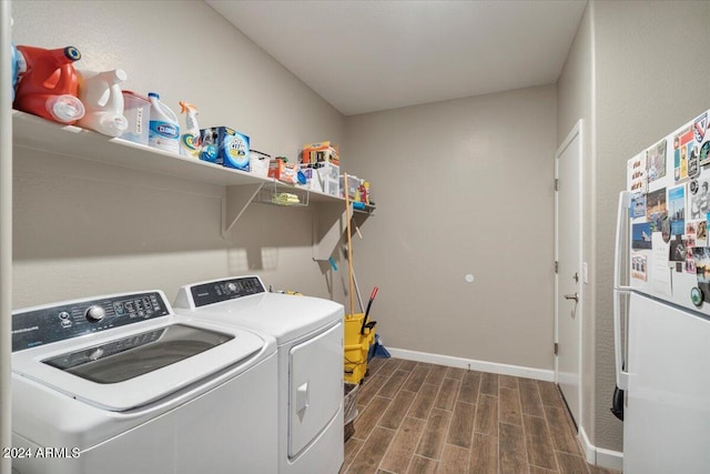 laundry area featuring dark hardwood / wood-style floors and washer and clothes dryer