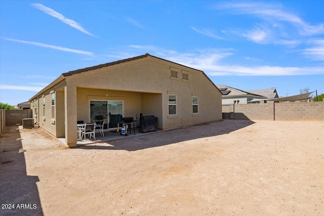 rear view of house featuring a patio area and central AC unit