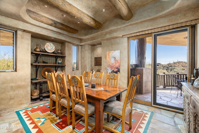 dining area with beam ceiling