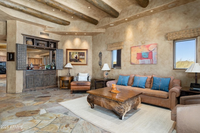 living room featuring beamed ceiling