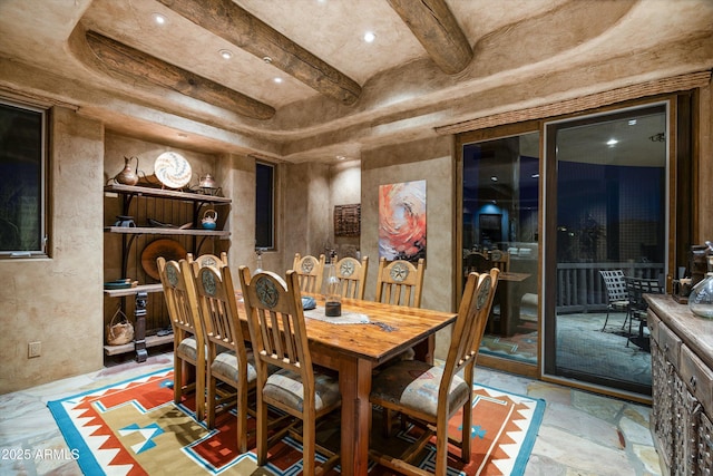 dining room featuring beamed ceiling