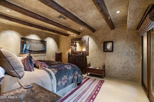 bedroom featuring carpet flooring and beam ceiling