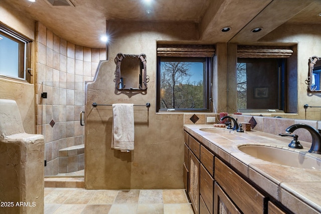 bathroom with vanity and a shower with shower door