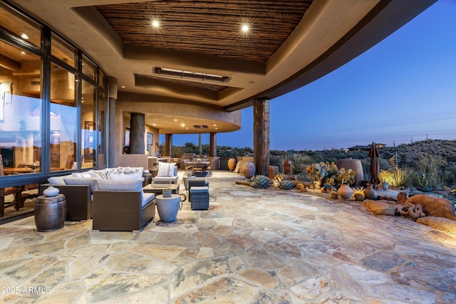 patio terrace at dusk featuring an outdoor living space