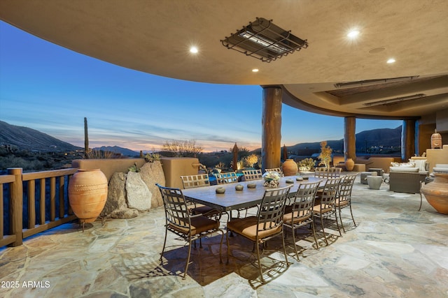 patio terrace at dusk featuring a mountain view