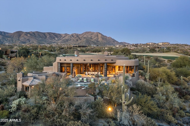 rear view of property featuring a mountain view