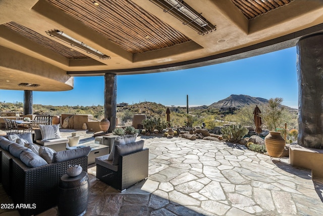 view of patio featuring outdoor lounge area and a mountain view