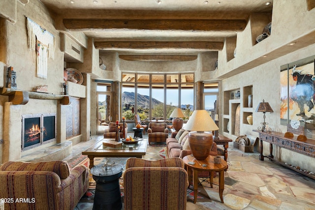 living room with beam ceiling and a mountain view