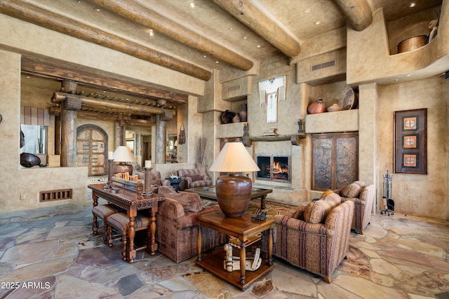 living room featuring a fireplace and beamed ceiling