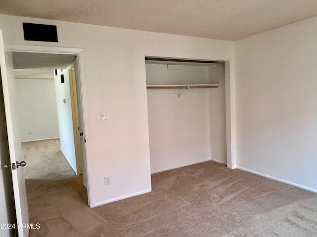 unfurnished bedroom with carpet floors and a closet