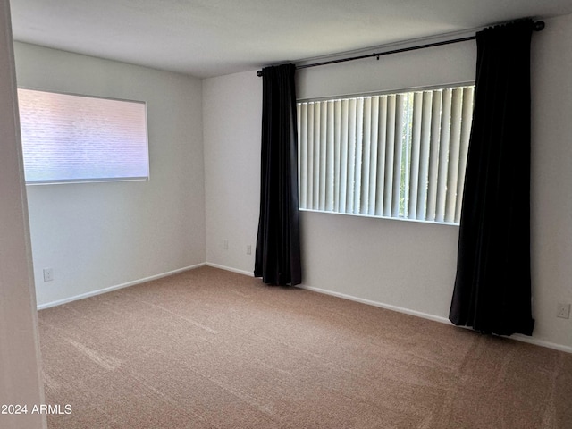 empty room with carpet and baseboards