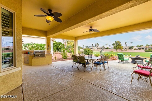 view of patio / terrace with an outdoor kitchen, grilling area, and ceiling fan