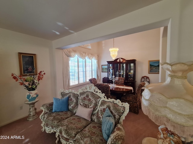 living room featuring carpet and a chandelier