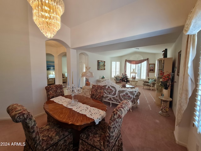 carpeted dining area featuring a chandelier