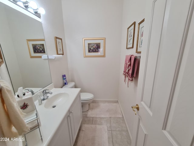 bathroom with tile patterned floors, vanity, and toilet