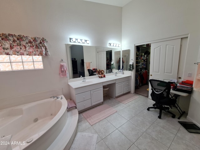 bathroom featuring tile patterned floors, a towering ceiling, a washtub, and vanity