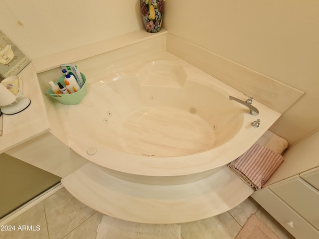 bathroom featuring tile patterned floors and a tub