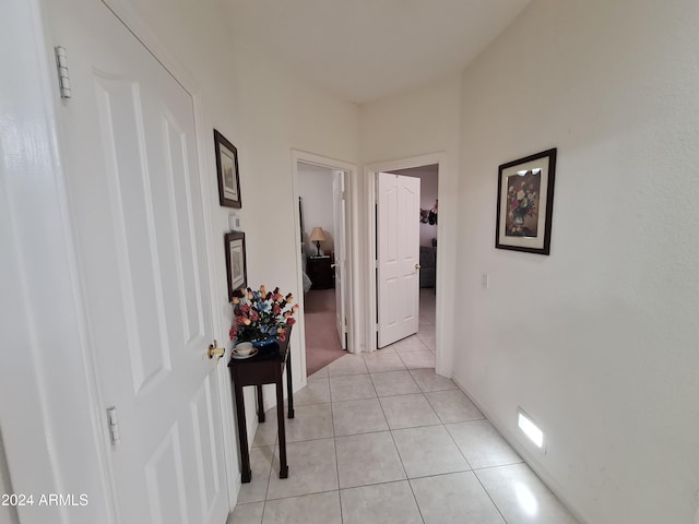 corridor with light tile patterned floors