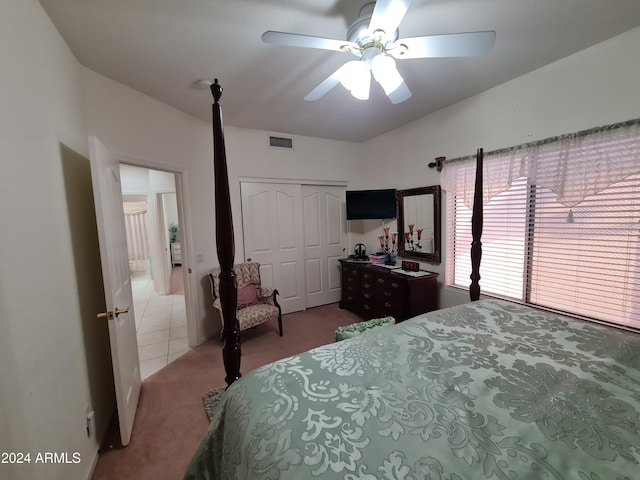 carpeted bedroom with a closet and ceiling fan