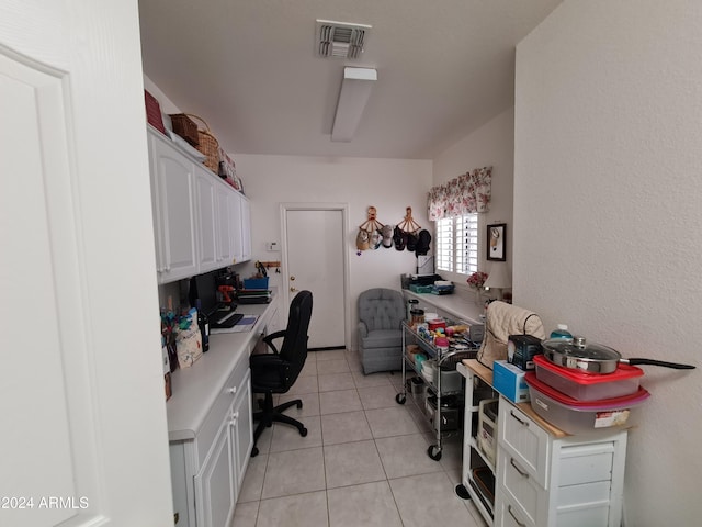 office space with built in desk and light tile patterned flooring