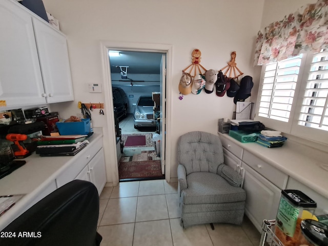 interior space with white cabinets and light tile patterned floors