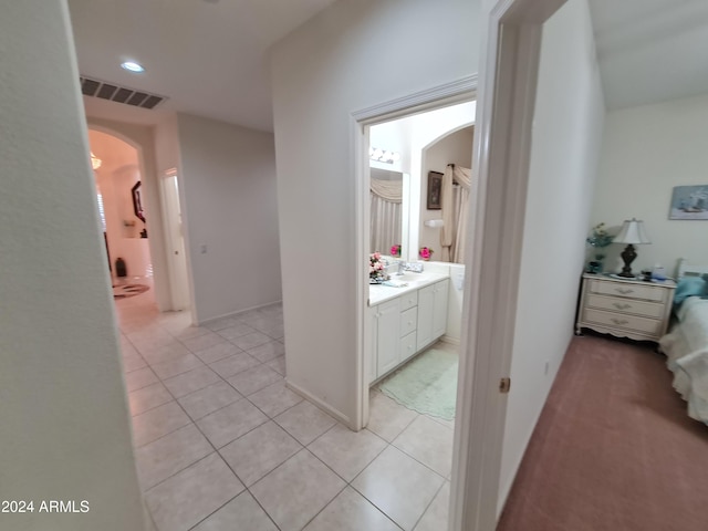 hall with light tile patterned floors