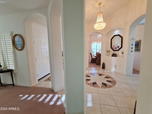 foyer entrance with a notable chandelier and light tile patterned floors