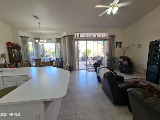 kitchen with pendant lighting, a center island, light tile patterned flooring, and a wealth of natural light