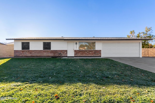 ranch-style home with a front lawn and a garage