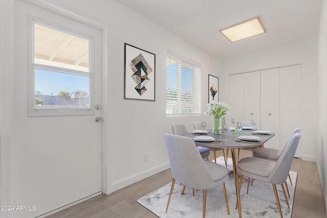 dining space with light wood-type flooring