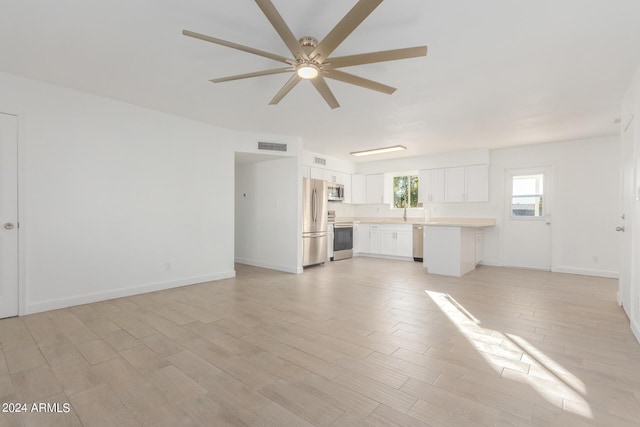 unfurnished living room featuring light wood-type flooring and ceiling fan