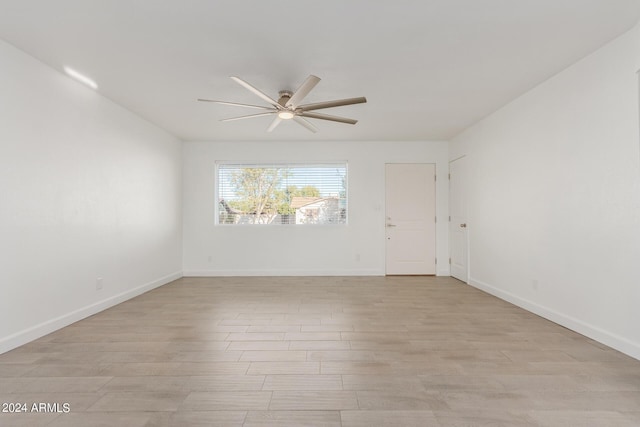 spare room with ceiling fan and light hardwood / wood-style flooring