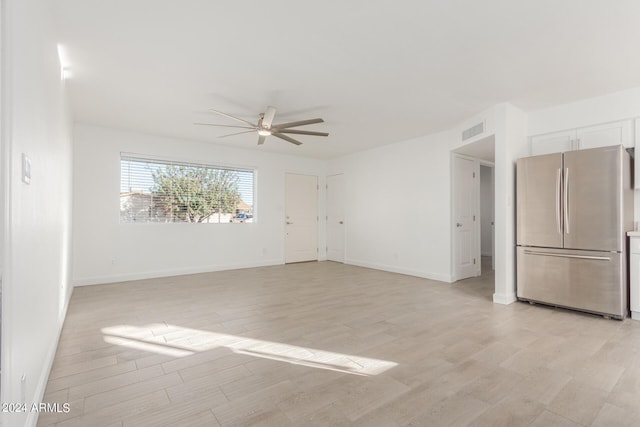 unfurnished living room featuring ceiling fan