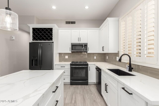 870 E Megan St, Gilbert, AZ 85295 - kitchen featuring black appliances, a sink, white cabinetry, backsplash, and recessed lighting