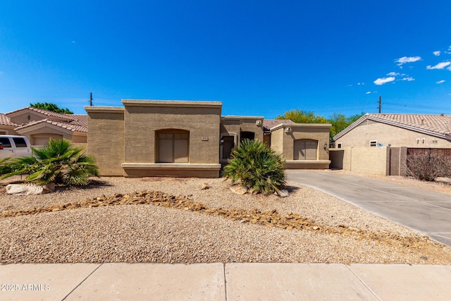 870 E Megan St, Gilbert, AZ 85295 - pueblo-style home featuring stucco siding, driveway, and fence