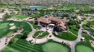 drone / aerial view with view of golf course and a residential view