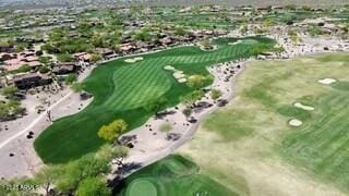 birds eye view of property with view of golf course and a residential view