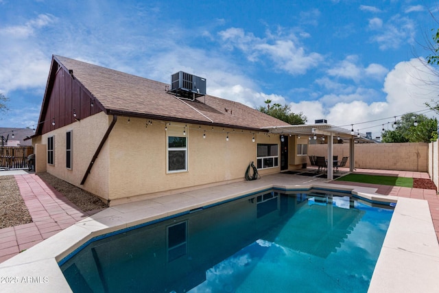 view of swimming pool featuring a patio area, central air condition unit, a fenced in pool, and a fenced backyard