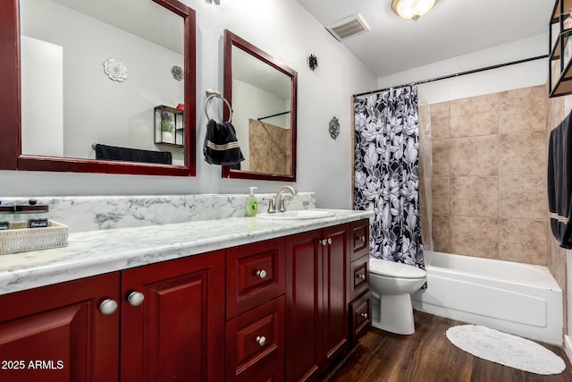 bathroom featuring vanity, shower / bathtub combination with curtain, wood finished floors, visible vents, and toilet