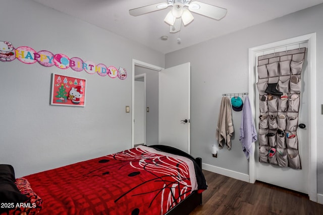 bedroom with ceiling fan, baseboards, and wood finished floors