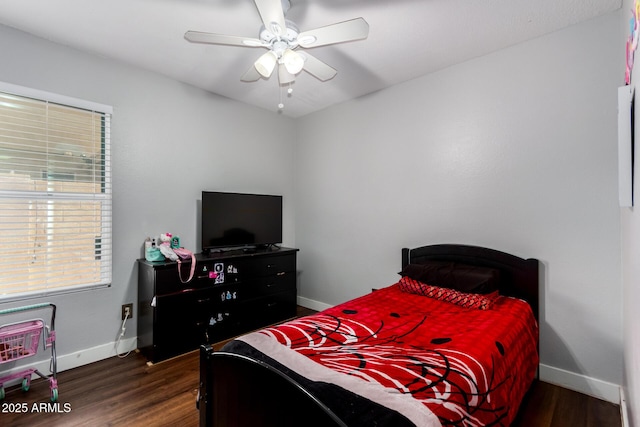 bedroom featuring ceiling fan, baseboards, and wood finished floors