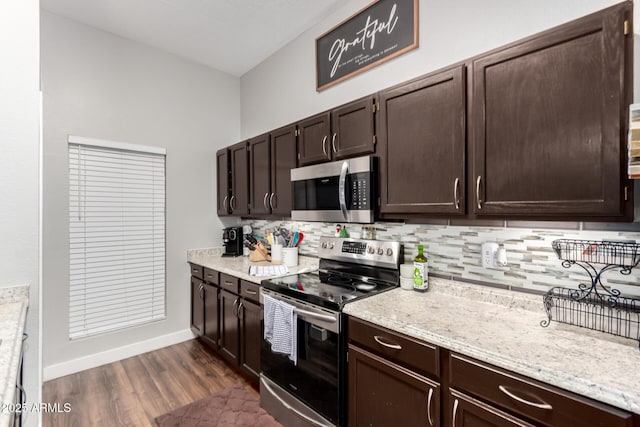 kitchen with decorative backsplash, dark brown cabinetry, and appliances with stainless steel finishes