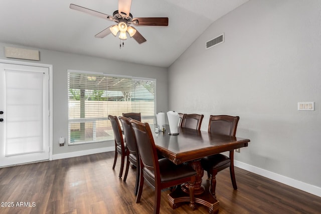 dining space with visible vents, baseboards, dark wood finished floors, vaulted ceiling, and a ceiling fan