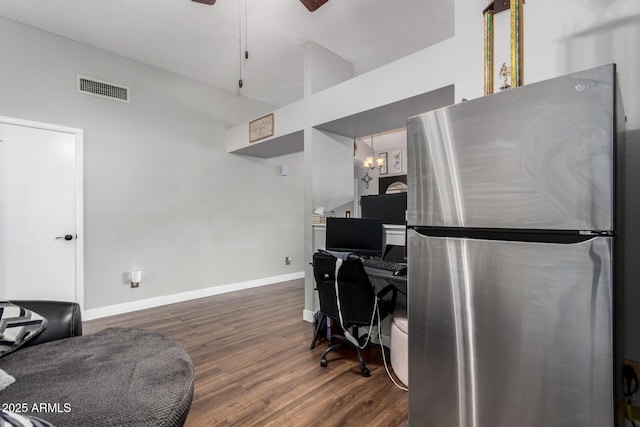 office with visible vents, baseboards, lofted ceiling, ceiling fan with notable chandelier, and dark wood-style flooring