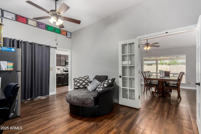 living area with dark wood finished floors, baseboards, and ceiling fan