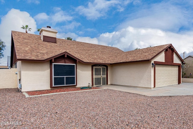 view of front of home featuring roof with shingles, a chimney, stucco siding, concrete driveway, and a garage